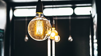 Vintage Edison Light Bulb Hanging in Dark Interior