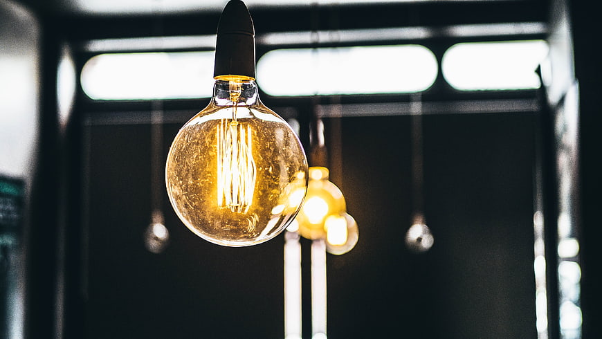 Vintage Edison Light Bulb Hanging in Dark Interior