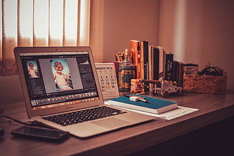 Home Office Workspace With Laptop, Notebook, And Books