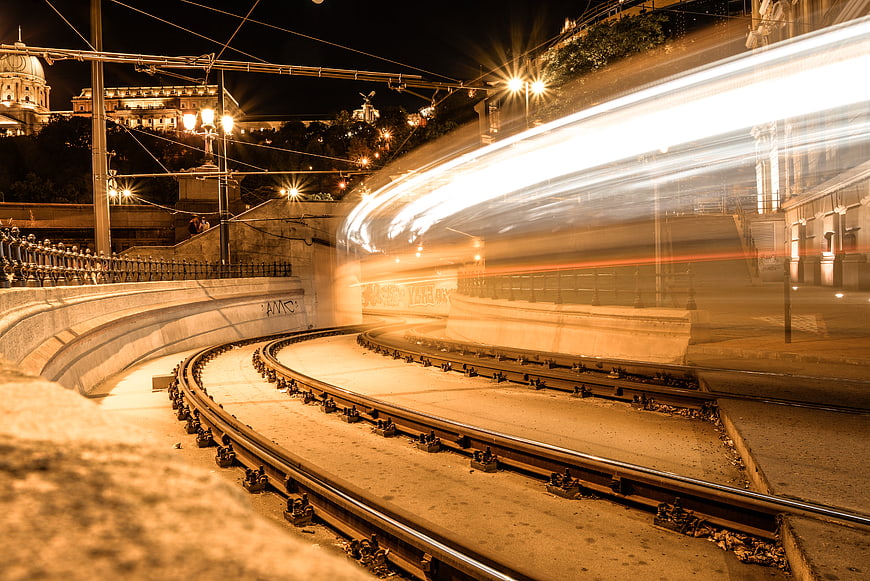 Long exposure tram light trails on curved tracks at night
