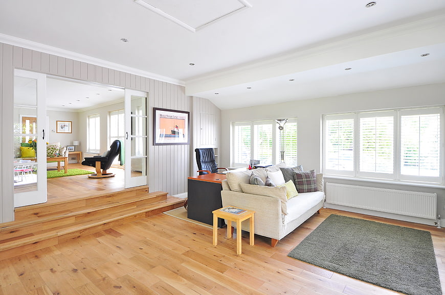 Bright modern living room with hardwood floors and white sofa