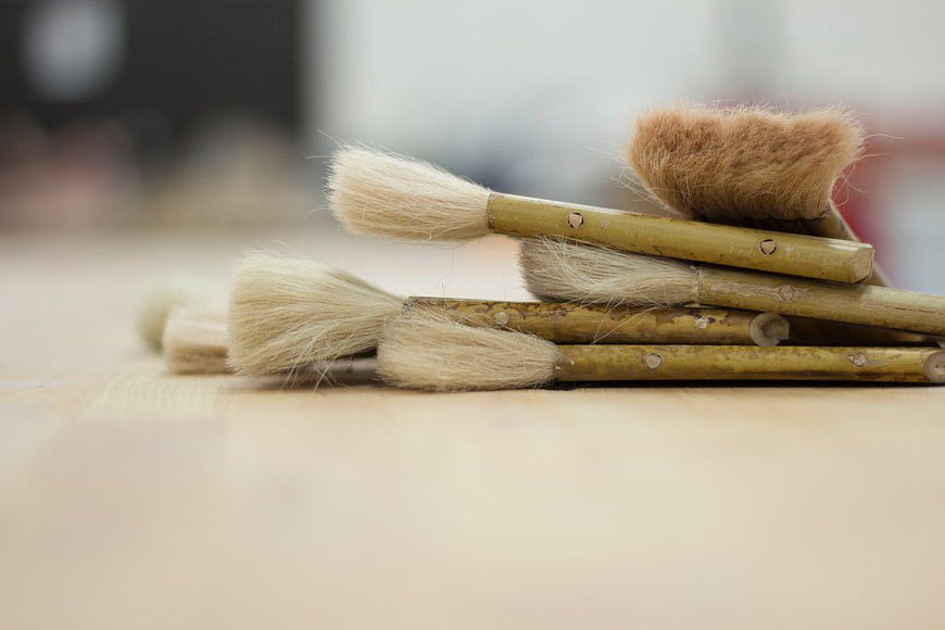 Natural Bristle Paint Brushes on Wooden Surface