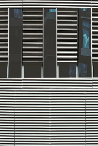 Modern building facade with horizontal slats and glass windows
