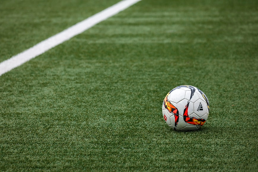 White Adidas Soccer Ball on Green Artificial Turf Field