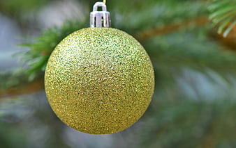 Gold Glitter Christmas Ornament Hanging On Pine Branch