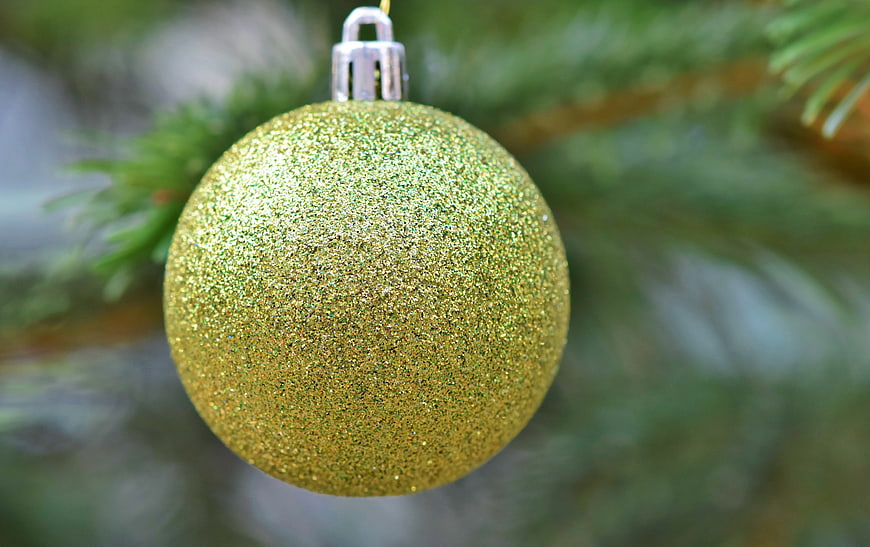 Gold Glitter Christmas Ornament Hanging On Pine Branch