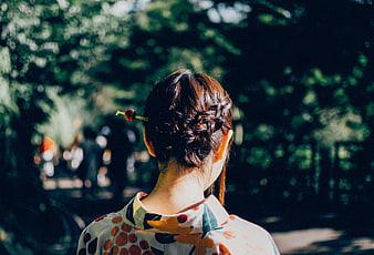 Woman with Braided Hair and Cherry Hairpin in Park
