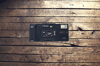 Vintage Black Premier Film Camera on Rustic Wood