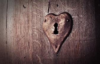 Vintage Heart-Shaped Keyhole on Old Wooden Door