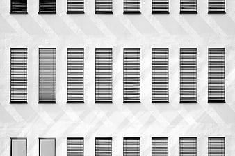 Black and white architectural facade with repeating window pattern