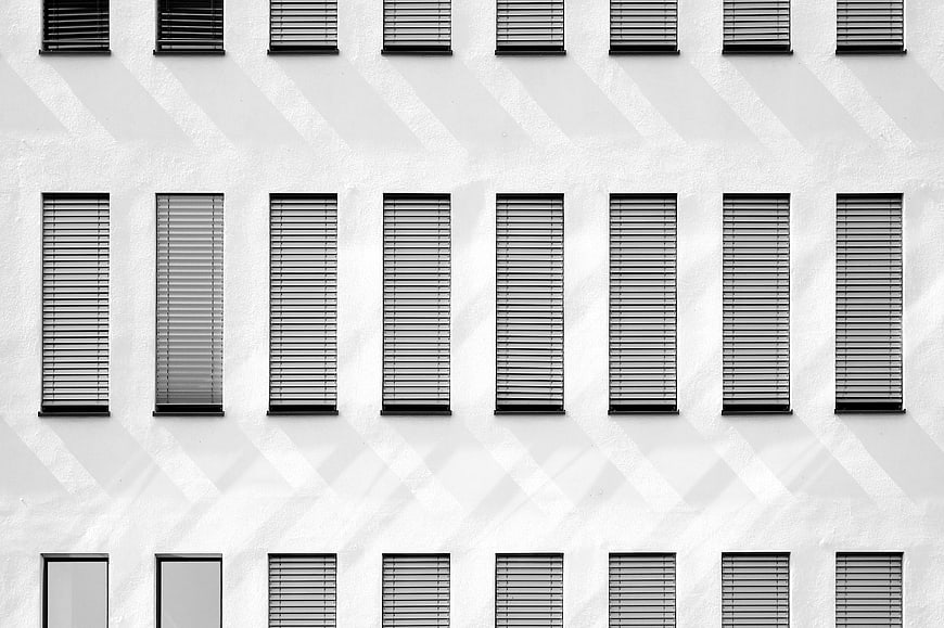 Black and white architectural facade with repeating window pattern