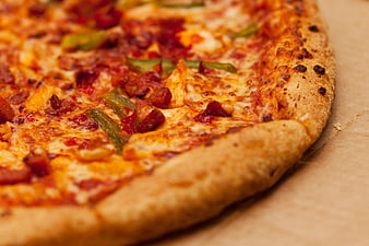 Close-up of freshly baked pizza with melted cheese and toppings