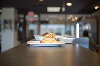 Sandwich on a counter in a blurred restaurant interior