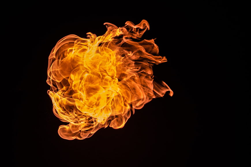 Vibrant orange fireball explosion on black background