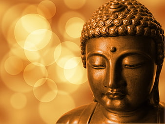 Golden Buddha Statue Head with Bokeh Background