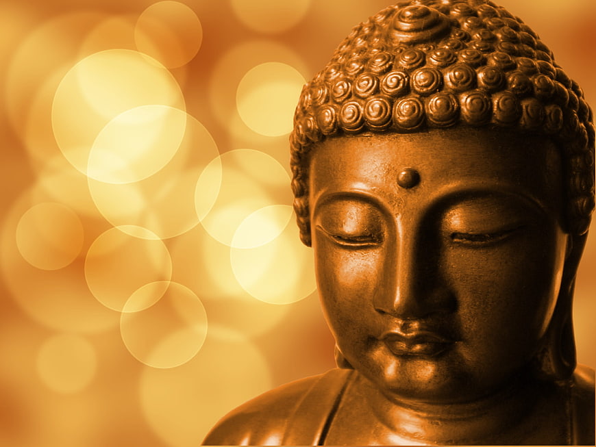 Golden Buddha Statue Head with Bokeh Background