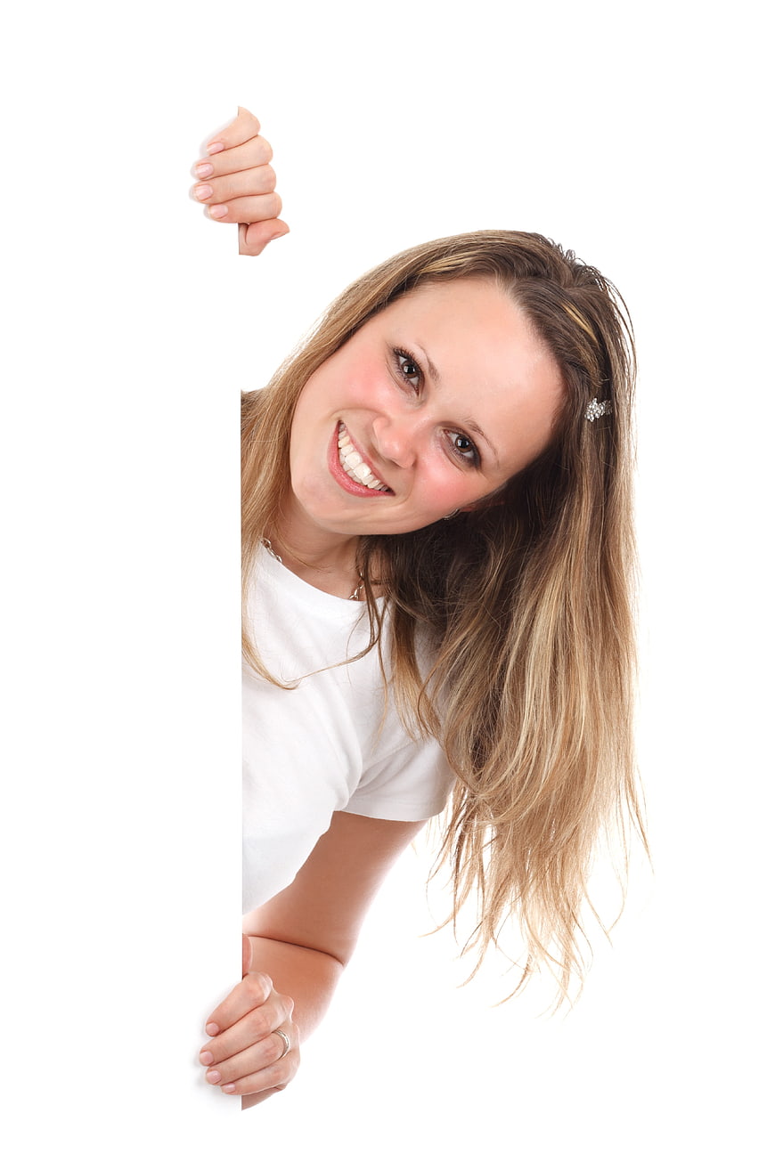 Happy woman peeking from behind blank white sign