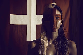 Woman with Cross Face Paint and Flag Background
