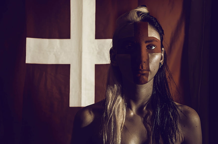 Woman with Cross Face Paint and Flag Background