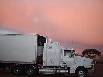White Semi Truck Parked Against Pink Sunset Sky