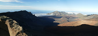 Panoramic View of Volcanic Crater with Clouds and Mountains