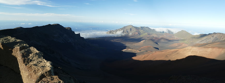 Panoramic View of Volcanic Crater with Clouds and Mountains