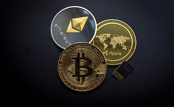 Bitcoin, Ethereum, and Ripple Coins with SD Card on Black Background