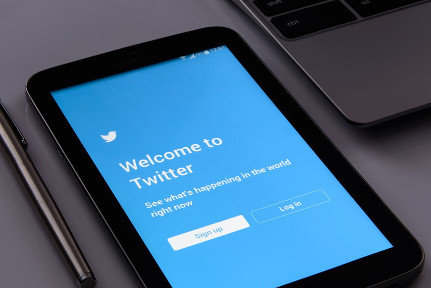 Tablet displaying Twitter welcome screen on desk