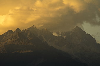 Moody Mountain Landscape With Golden Sunset Sky And Misty Valley