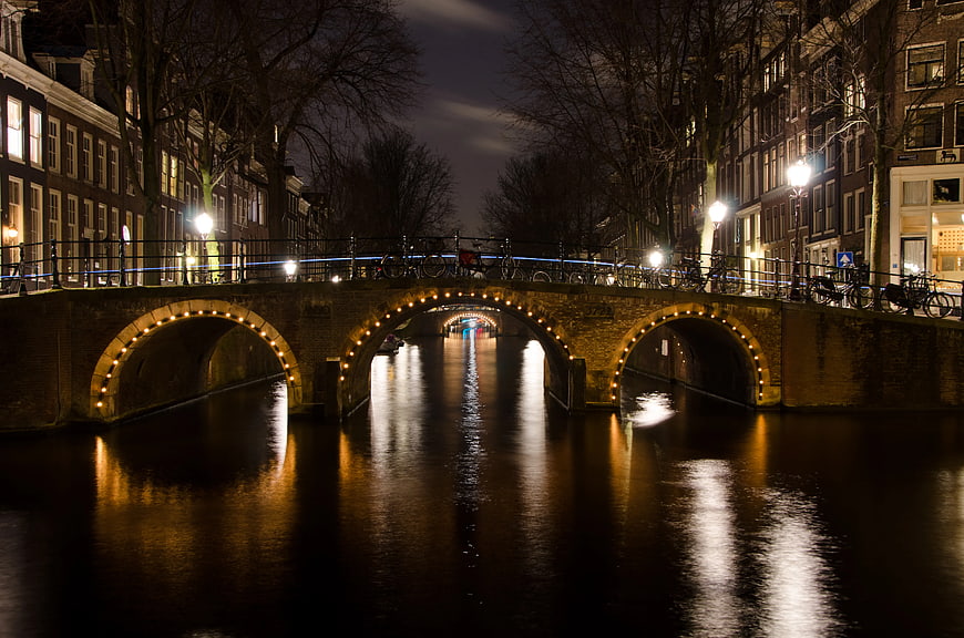 Amsterdam Canal Bridge at Night with Reflections