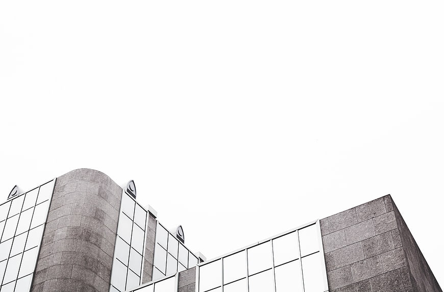 Modern architectural building facade with stone and glass