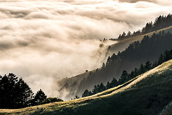 Misty Mountain Landscape with Sunbeams Through Clouds