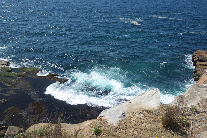 Ocean waves crashing against rocky coastal cliffs
