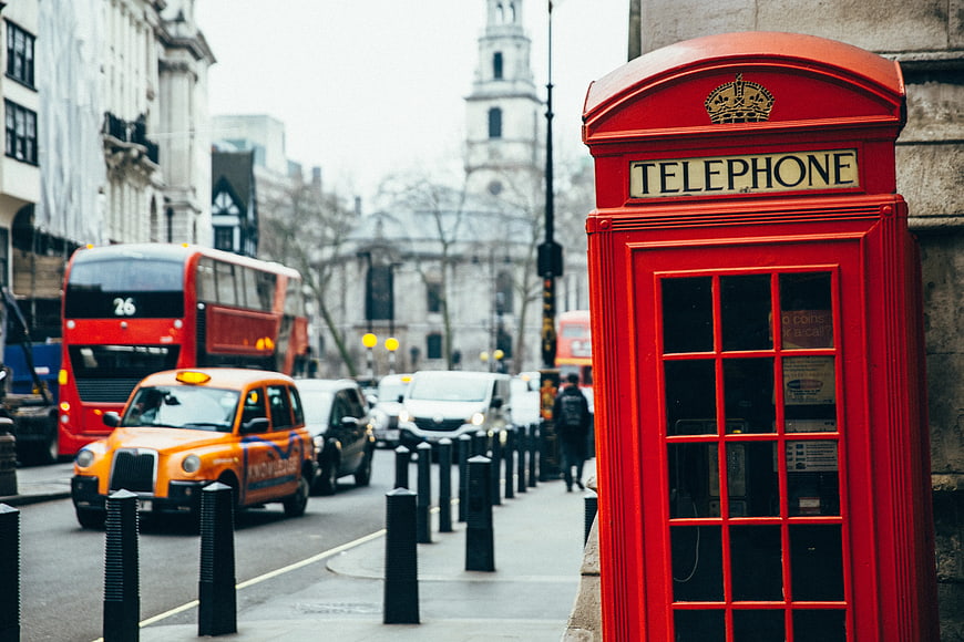Classic Red London Telephone Box on Busy Street
