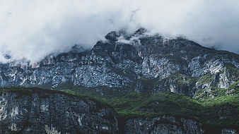 Majestic Rocky Mountain Peaks Shrouded in Mist and Clouds