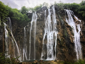 Majestic Multi-Tiered Waterfall Cascading Down Rocky Cliff