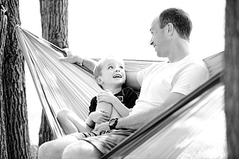 Father and Son Laughing Together in Hammock