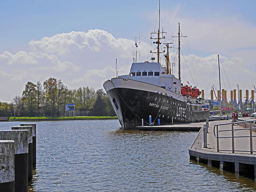Historic black pilot boat Kapitan Bleeker docked at harbor