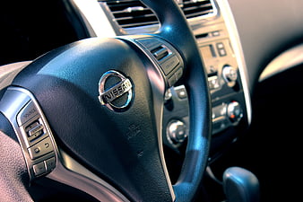 Close-up of Nissan steering wheel and car interior dashboard