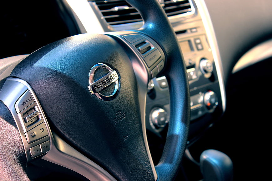 Close-up of Nissan steering wheel and car interior dashboard