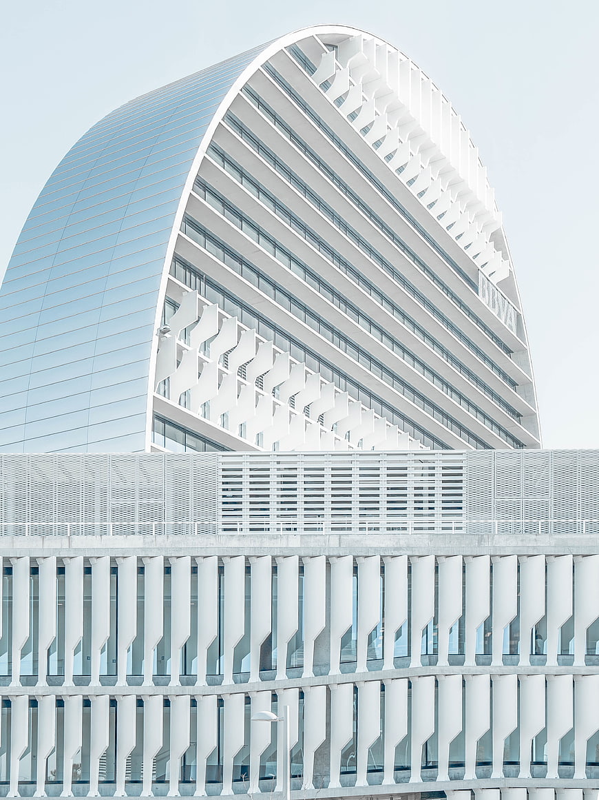 Modern white curved architecture with geometric facade details