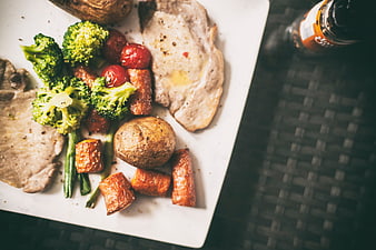 Overhead view of pork escalopes with roasted vegetables