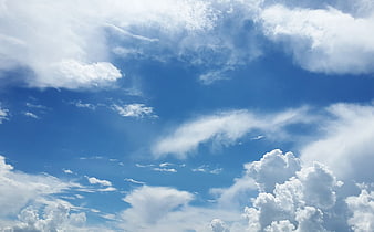Blue Sky With White Cumulus Clouds And Wispy Cirrus