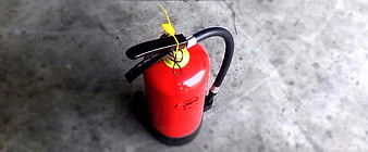 Red fire extinguisher on concrete floor