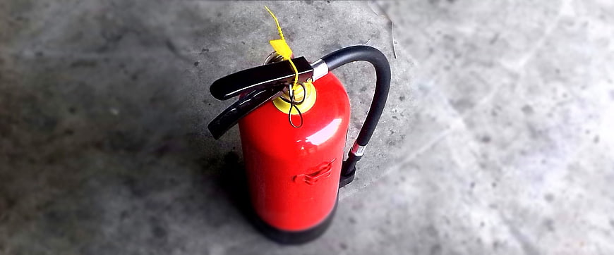 Red fire extinguisher on concrete floor