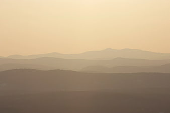 Hazy Mountain Layers at Sunset