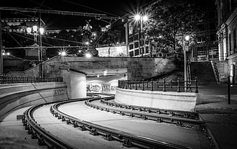 Curved tram tracks entering a tunnel at night in Budapest
