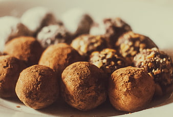 Close-up of assorted chocolate truffles with cocoa and nuts