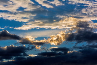 Dramatic sunset sky with golden clouds and blue atmosphere