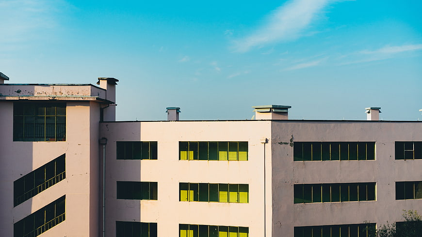 Modern Pink Office Building with Blue Sky